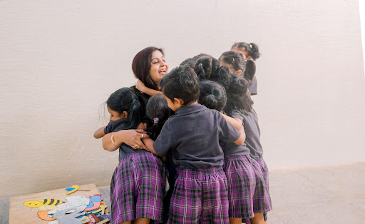 Ekya Early Year kids playing with teacher